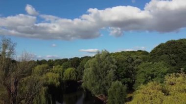 Water Birds are Swimming in the Lake Water of Local Public Park of Luton England Great Britain on a hot Day of Summer 2022, Drone's Camera Footage.