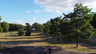 Water Birds are Swimming in the Lake Water of Local Public Park of Luton England Great Britain on a hot Day of Summer 2022, Drone's Camera Footage.