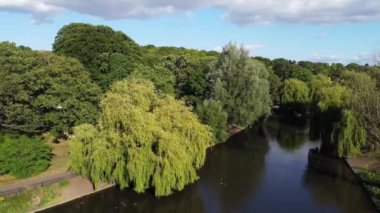 Water Birds are Swimming in the Lake Water of Local Public Park of Luton England Great Britain on a hot Day of Summer 2022, Drone's Camera Footage.