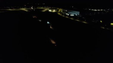 Illuminated Roads and Traffic over British City During Night