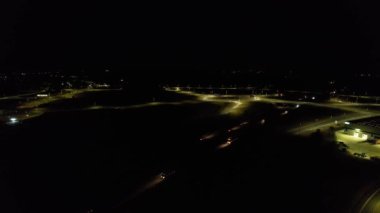 Illuminated Roads and Traffic over British City During Night