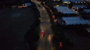 Illuminated Roads and Traffic over British City During Night