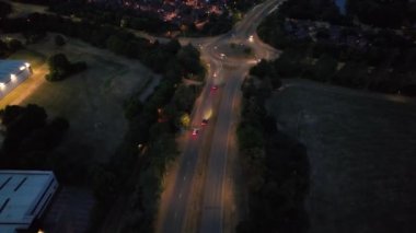 Illuminated Roads and Traffic over British City During Night