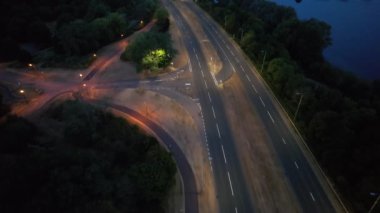 Illuminated Roads and Traffic over British City During Night
