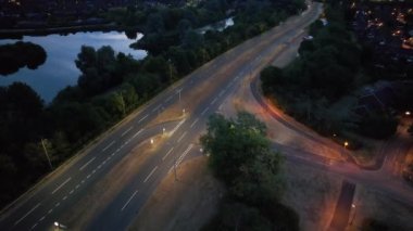 Illuminated Roads and Traffic over British City During Night
