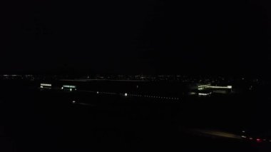 Illuminated Roads and Traffic over British City During Night