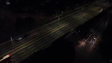 Illuminated Roads and Traffic over British City During Night