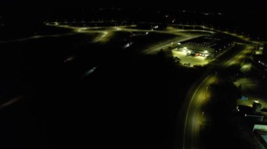 Illuminated Roads and Traffic over British City During Night