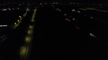 Illuminated Roads and Traffic over British City During Night