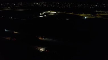 Illuminated Roads and Traffic over British City During Night