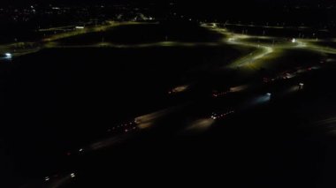 Illuminated Roads and Traffic over British City During Night