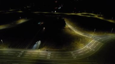 Illuminated Roads and Traffic over British City During Night