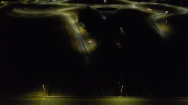 Illuminated Roads and Traffic over British City During Night
