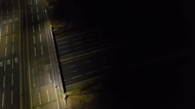 Illuminated Roads and Traffic over British City During Night