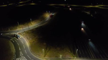 Illuminated Roads and Traffic over British City During Night