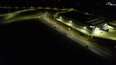 Illuminated Roads and Traffic over British City During Night