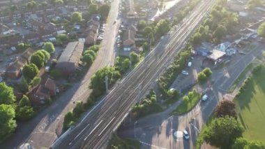 Aerial Footage of British City of Luton, England, Close to Leagrave Railway Station, Train on Tracks and Houses
