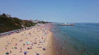 Beautiful Aerial View of Sea View and Sandy Beach of Bournemouth City of England UK, Drone's footage. People are Enjoying hot weather of England on 18th July 2022