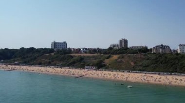 Beautiful Aerial View of Sea View and Sandy Beach of Bournemouth City of England UK, Drone's footage. People are Enjoying hot weather of England on 18th July 2022