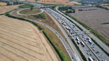 Aerial View of British Motorways With Traffic at Peak Time, High Angle Footage taken with drone's camera at Luton City of England UK, M1 J11 Motorways Junction Interchange.