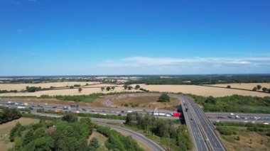 Aerial View of British Motorways With Traffic at Peak Time, High Angle Footage taken with drone's camera at Luton City of England UK, M1 J11 Motorways Junction Interchange.