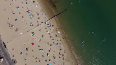 Beautiful Aerial View of Sea View and Sandy Beach of Bournemouth City of England UK, Drone's footage. People are Enjoying hot weather of England on 18th July 2022