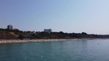 Beautiful Aerial View of Sea View and Sandy Beach of Bournemouth City of England UK, Drone's footage. People are Enjoying hot weather of England on 18th July 2022