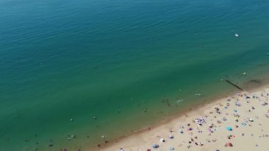 Beautiful Aerial View of Sea View and Sandy Beach of Bournemouth City of England UK, Drone's footage. People are Enjoying hot weather of England on 18th July 2022