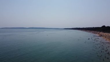 Beautiful Aerial View of Sea View and Sandy Beach of Bournemouth City of England UK, Drone's footage. People are Enjoying hot weather of England on 18th July 2022