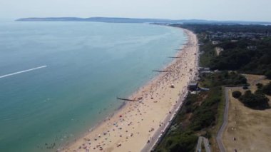 Beautiful Aerial View of Sea View and Sandy Beach of Bournemouth City of England UK, Drone's footage. People are Enjoying hot weather of England on 18th July 2022