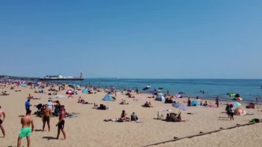 Beautiful Aerial View of Sea View and Sandy Beach of Bournemouth City of England UK, Drone's footage. People are Enjoying hot weather of England on 18th July 2022