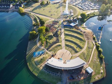High Angle Footage of Willen Lake, Water Sports and Public Park of England. which is located at Milton Keynes, England.+ People are Enjoying at Lake on a Hot Sunny Day of Summer. Video Clip Captured on 21-Aug-2022. Beautiful Aerial Drone's Footage.