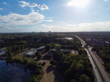 High Angle Footage of Willen Lake, Water Sports and Public Park of England. which is located at Milton Keynes, England.+ People are Enjoying at Lake on a Hot Sunny Day of Summer. Video Clip Captured on 21-Aug-2022. Beautiful Aerial Drone's Footage.