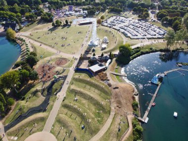 High Angle Footage of Willen Lake, Water Sports and Public Park of England. which is located at Milton Keynes, England.+ People are Enjoying at Lake on a Hot Sunny Day of Summer. Video Clip Captured on 21-Aug-2022. Beautiful Aerial Drone's Footage.