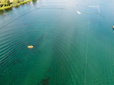 High Angle Footage of Willen Lake, Water Sports and Public Park of England. which is located at Milton Keynes, England.+ People are Enjoying at Lake on a Hot Sunny Day of Summer. Video Clip Captured on 21-Aug-2022. Beautiful Aerial Drone's Footage.