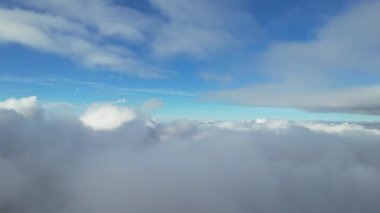 Most Beautiful Aerial View of Above the Clouds in the Morning. dramatically fast moving clouds