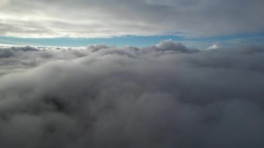 Most Beautiful Aerial View of Above the Clouds in the Morning. dramatically fast moving clouds