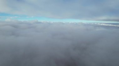 Most Beautiful Aerial View of Above the Clouds in the Morning. dramatically fast moving clouds