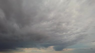 Time lapse rain clouds over British city at sunset time