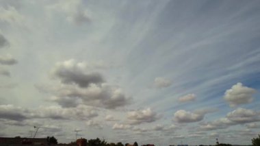 Time lapse rain clouds over British city at sunset time
