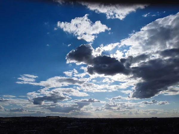 Aerial View of clouds and City houses. Beautiful High Angle Altitude View of Clouds and British Town of England UK, Air plane view at 360 degree.