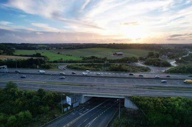 High Angle View of British Motorways at M1 and M25 Interchange. Highways are Passing from Beautiful Landscape with agricultural farms. Aerial View was captured with drone's camera on 7th Sep 2022. 