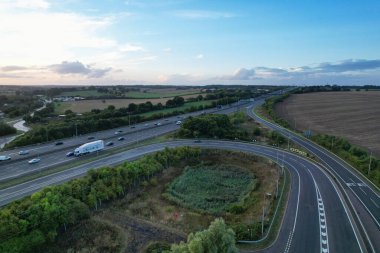 High Angle View of British Motorways at M1 and M25 Interchange. Highways are Passing from Beautiful Landscape with agricultural farms. Aerial View was captured with drone's camera on 7th Sep 2022. 