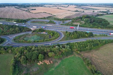 High Angle View of British Motorways at M1 and M25 Interchange. Highways are Passing from Beautiful Landscape with agricultural farms. Aerial View was captured with drone's camera on 7th Sep 2022. 