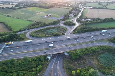 High Angle View of British Motorways at M1 and M25 Interchange. Highways are Passing from Beautiful Landscape with agricultural farms. Aerial View was captured with drone's camera on 7th Sep 2022. 