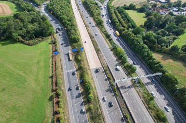 High Angle View of British Motorways at M1 and M25 Interchange. Highways are Passing from Beautiful Landscape with agricultural farms. Aerial View was captured with drone's camera on 7th Sep 2022. 
