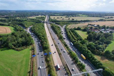 High Angle View of British Motorways at M1 and M25 Interchange. Highways are Passing from Beautiful Landscape with agricultural farms. Aerial View was captured with drone's camera on 7th Sep 2022. 