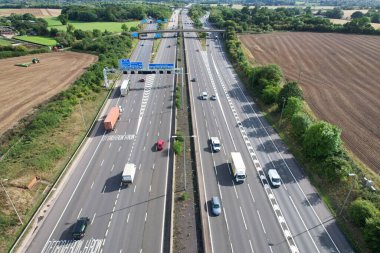 High Angle View of British Motorways at M1 and M25 Interchange. Highways are Passing from Beautiful Landscape with agricultural farms. Aerial View was captured with drone's camera on 7th Sep 2022. 
