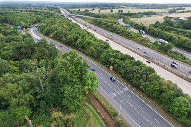 High Angle View of British Motorways at M1 and M25 Interchange. Highways are Passing from Beautiful Landscape with agricultural farms. Aerial View was captured with drone's camera on 7th Sep 2022. 