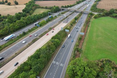High Angle View of British Motorways at M1 and M25 Interchange. Highways are Passing from Beautiful Landscape with agricultural farms. Aerial View was captured with drone's camera on 7th Sep 2022. 